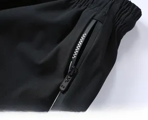 Close-up of waterproof heat-sealed zipper pocket and elastic waistband on shorts