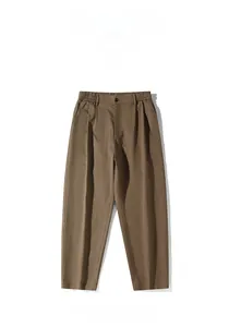 Detail of khaki casual trousers featuring elastic waist with button and front pleats