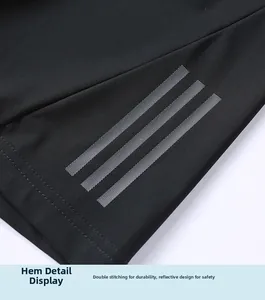 Detail view of black shorts with reflective three-stripe side design and double stitching