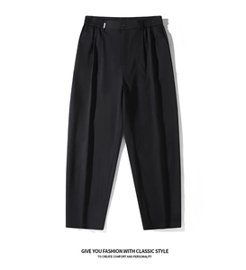 Detail of black casual trousers featuring an elastic waistband and front button closure