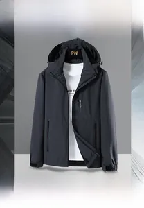 Detail of grey men's hooded jacket featuring adjustable velcro cuffs and zip pockets