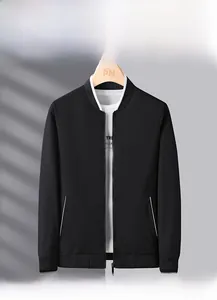 Detail of black baseball collar jacket with white stripe pockets and ribbed cuffs