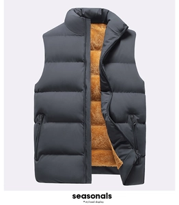 Detail of men's quilted vest with warm ginger fleece lining and black zippers