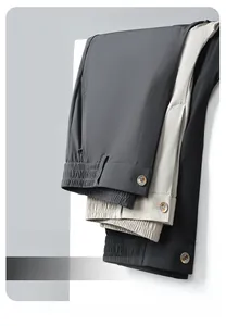 Detailed macro view showing grey, beige, and black fabric textures of premium suit trousers