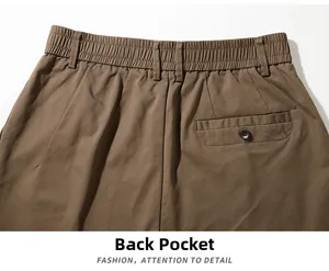 Detail view of khaki cotton trousers featuring elastic waist and buttoned back pocket
