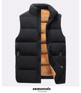 Detail of men's winter vest with black quilted exterior and warm brown fleece lining