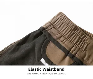 Detail view of khaki and black elastic waistband with reinforced hem and size tag