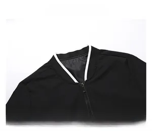 Detail view of black standing collar jacket with white trim and metal zipper closure
