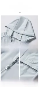 Detail of light blue sun protection jacket featuring UPF 50+ logo and reflective fashion print