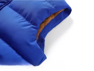 Detail of windproof blue vest armhole with thick warm brown fleece lining and stitching