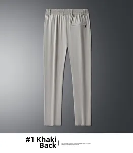 Detail view of khaki dress pants back side featuring elastic waist and zip pocket