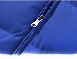 Detail view of the silver metal zipper and Klein blue quilted fabric on a puffer vest