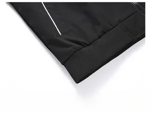 Detail showing the ribbed elastic hem and white striped pocket on this black jacket
