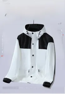 Detail of color-block windbreaker jacket with metal snap buttons and drawstring hood