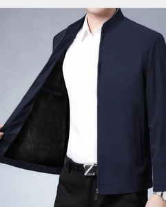 Detail of navy business jacket showing windproof fabric and warm black fleece lining