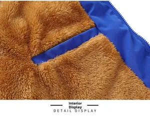 Detail display of the warm brown faux shearling lining and inner pocket of the blue vest