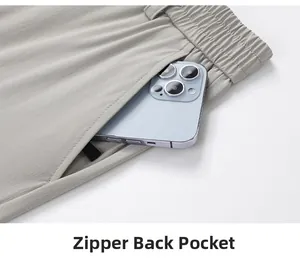 Close-up of light grey dress trousers with zippered back pocket for smartphone storage