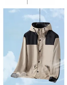 Detail of outdoor windbreaker featuring khaki contrast panels and breathable fabric