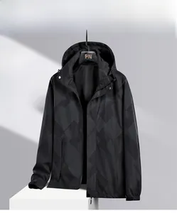 Close-up of black windbreaker featuring breathable mesh lining and geometric grid pattern