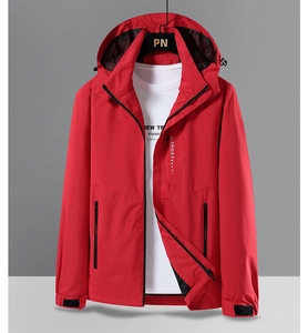 Detail of red hooded hiking jacket showing functional zip pockets and mesh lining texture