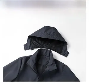 Detail view of a men's outdoor jacket showing the detachable hood and windproof zipper design