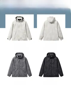 Detail view of khaki, gray, and black waterproof windbreaker jackets for men outdoors