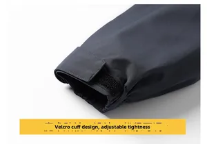 Detailed close-up of dark grey outdoor jacket cuff with adjustable velcro fastener