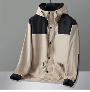 Detail of khaki outdoor jacket showing black contrast panels and adjustable hood drawstrings