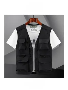 Detail of black multi-pocket utility fishing vest with functional nylon and flap pockets