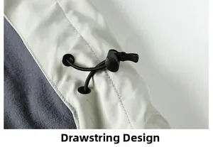 Detail of adjustable drawstring and toggle on a beige jacket with soft gray lining