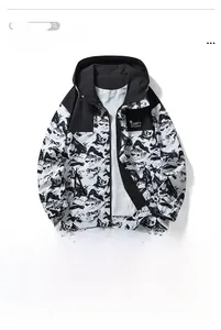 Close-up detail of the black and white abstract print on a hooded windbreaker jacket