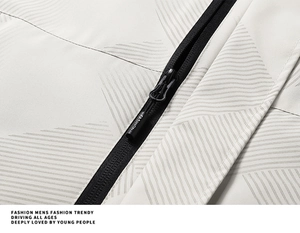 Macro shot of ivory jacket with gray geometric pattern and black FASHION zipper detail