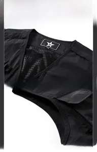 Detail of mesh lining and star emblem stitching on a black outdoor fishing vest