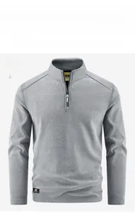 Detail of grey quarter-zip fleece pullover showing size label and premium knit texture