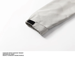 Detail of adjustable velcro cuff and geometric textured fabric on men's outdoor jacket