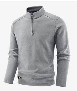 Detail of grey men's quarter-zip fleece pullover with stand collar and sport label