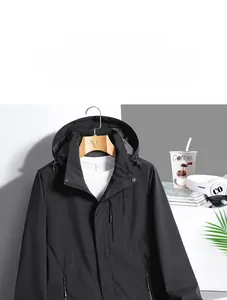Close-up of waterproof black outdoor jacket showing interior size label and hood detail