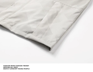 Detail of light gray jacket hem with geometric triangle texture and high density fabric
