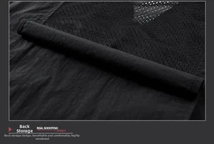 Macro detail of breathable mesh fabric and back storage pocket on black outdoor vest