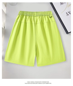 Detail of neon green work shorts featuring elastic waistband and black D-ring hook detail