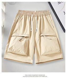 Detailed view of khaki cargo shorts featuring elastic drawstring waist and large flap pockets