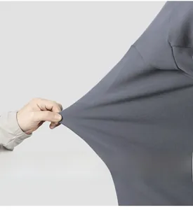 Close-up of the highly elastic grey knitted fabric showing superior stretch and texture