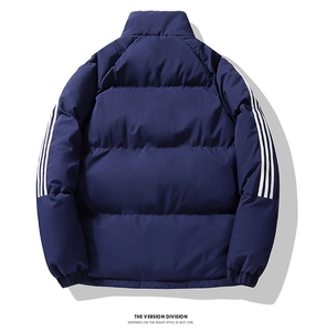 Detail view of navy blue winter jacket featuring classic three white stripes on sleeves
