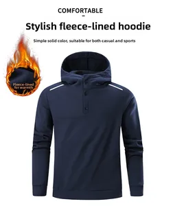 Detail of navy blue fleece hoodie featuring button neckline and white shoulder patches