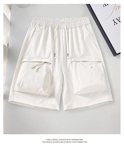 Macro detail of white ripstop cargo shorts showing durable textured fabric and large side pocket