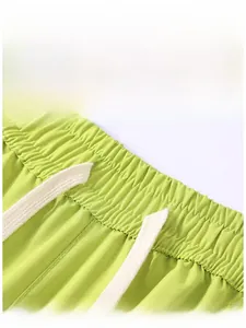 Detail of green cargo shorts featuring elastic waistband and durable ripstop fabric