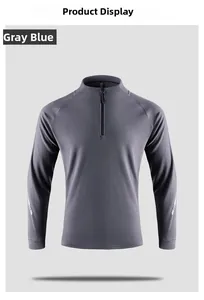 Detail of grey-blue athletic pullover showing reflective sleeve strips and half-zip collar