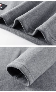 Close-up of grey fleece fabric texture and high-quality hem stitching with a logo patch