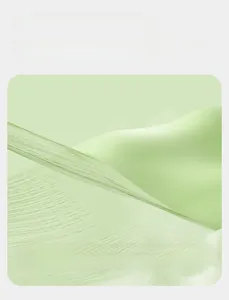 Detail view of breathable light green mesh fabric with honeycomb texture and moisture absorption