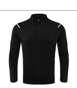 Detail view of black sports jacket featuring reflective shoulder strips and full zipper